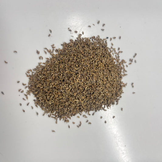 Pile of brown seeds on a white surface