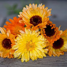 Bouquet of  flowers in orange and yellow on a wooden surface