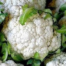 Close-up of cauliflower with green leaves